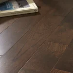 Close-up of dark stained oak wood floor planks.