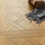 Close-up of oak Versailles pattern flooring