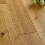 Close-up of oak floorboards and white flowers