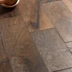 Close-up of textured dark wood flooring with knots.