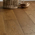 Low-angle view of wide-plank oak wood flooring