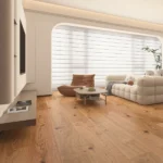 Minimalist living room with warm oak floors and large window