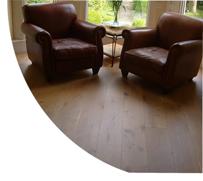 Natural oak wood flooring in a cozy seating area.