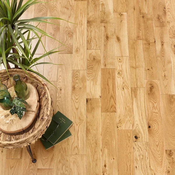 Overhead view of narrow plank oak engineered wood flooring with natural knots