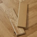 Two oak parquet blocks on a herringbone floor.