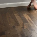 Wide shot of dark, rustic oak wood floor planks